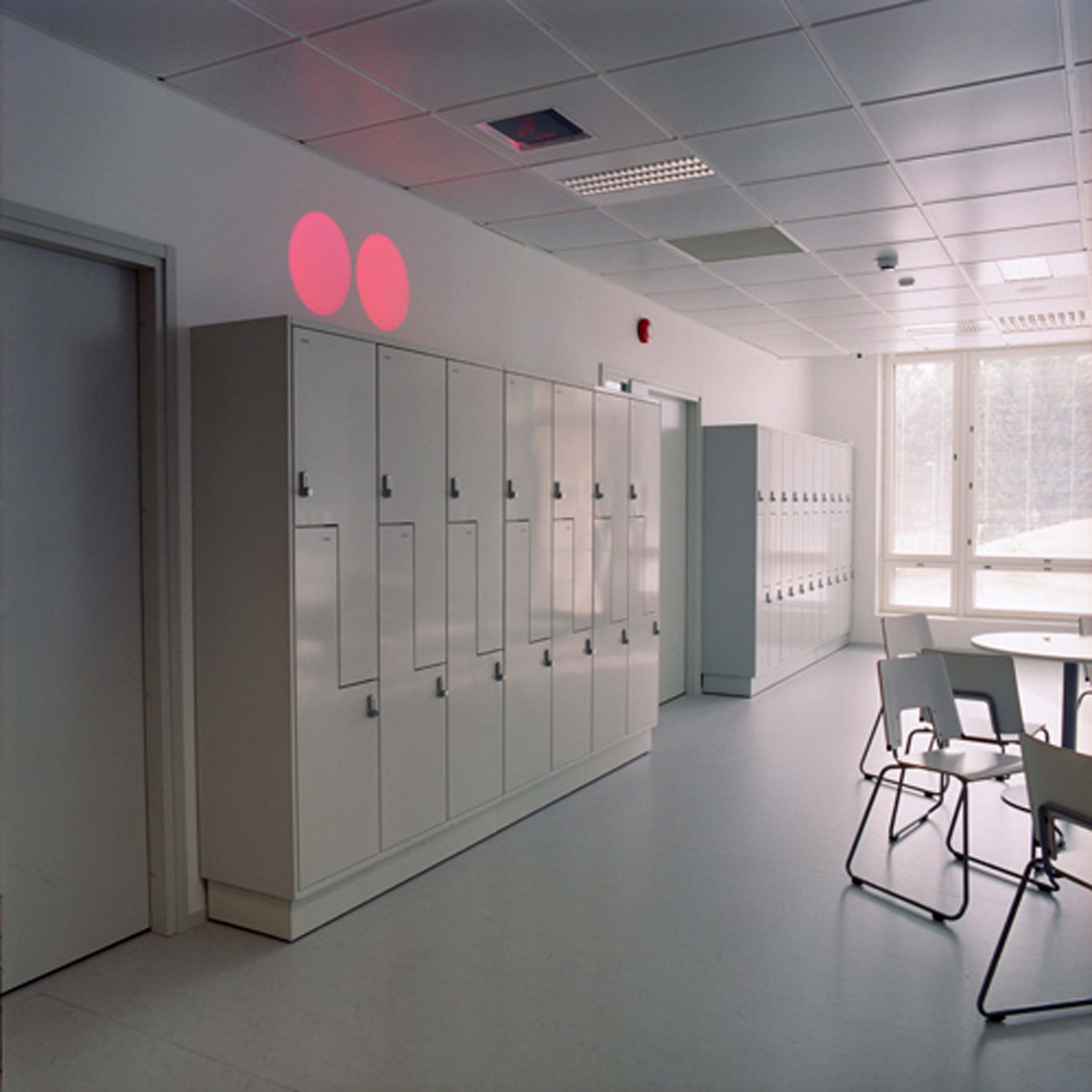 Pair of pink and red spots on top of white lockers