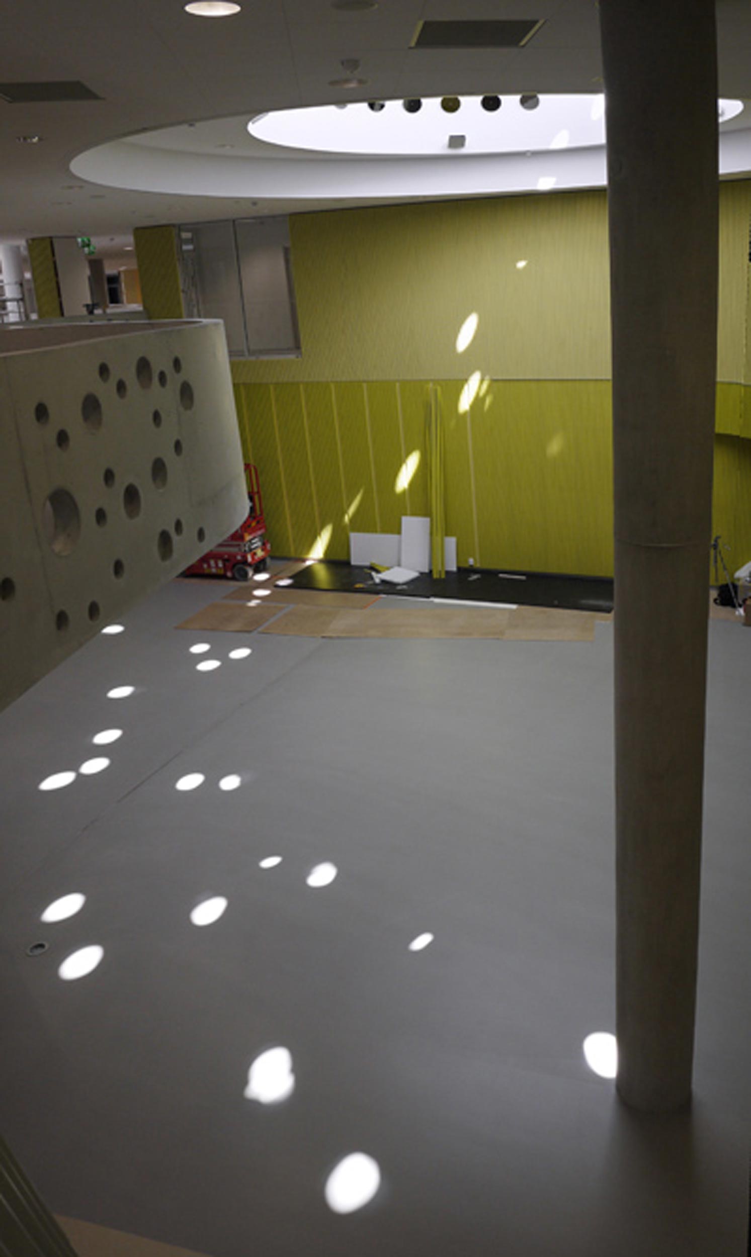 Installation from the side with spots of sunlight reflections spread around the space