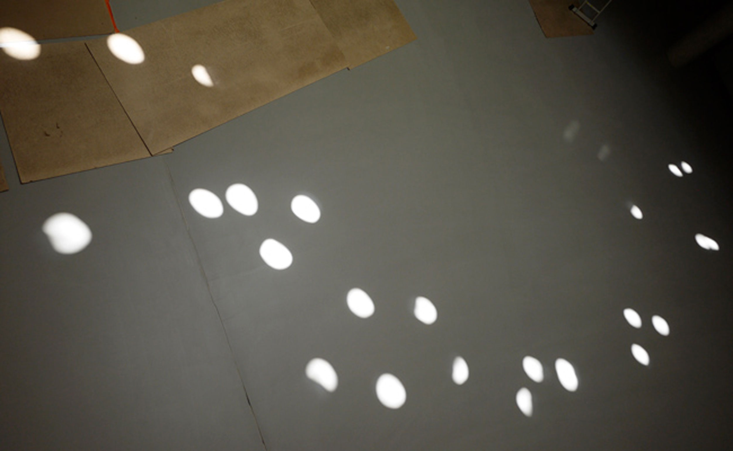 Close-up of spots of sunlight reflections on the floor