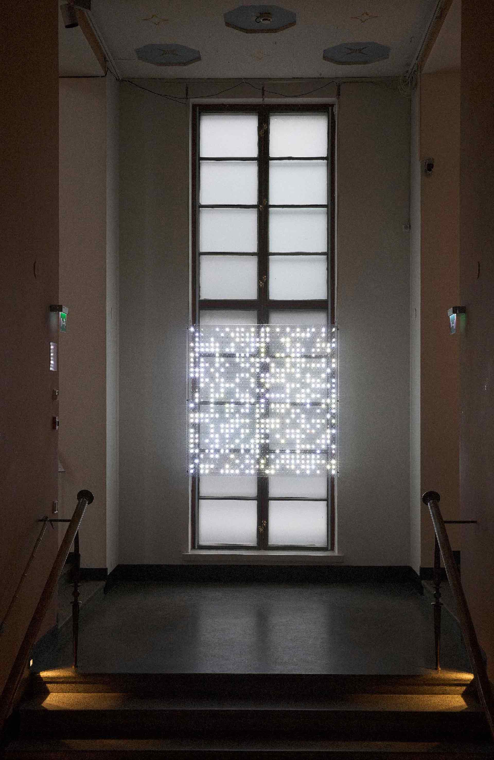 Artwork of transparent screen with white LED lights as pixels in a grid