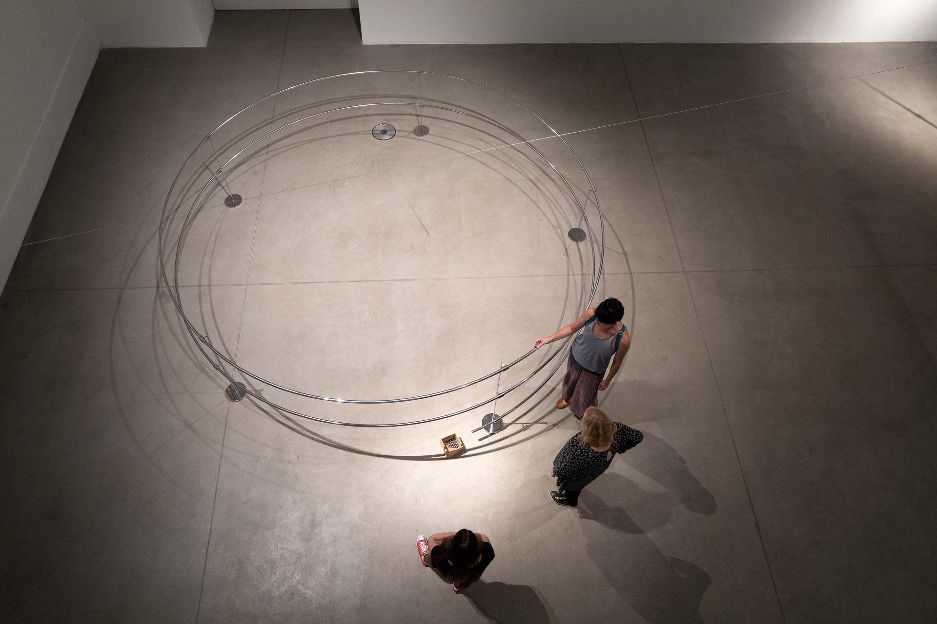 Orbita: top view on setup of artwork with 3 people