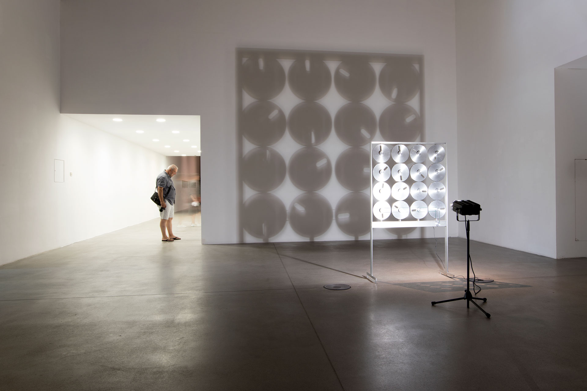Reel to Reel: total of artwork in exhibition space with shadows on wall behind