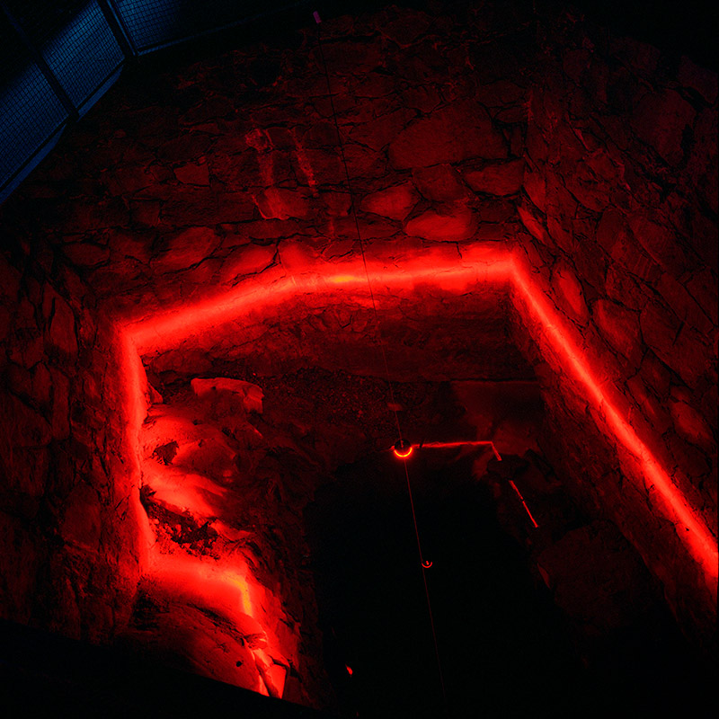 Critial Level: top view on line of red light on walls of well