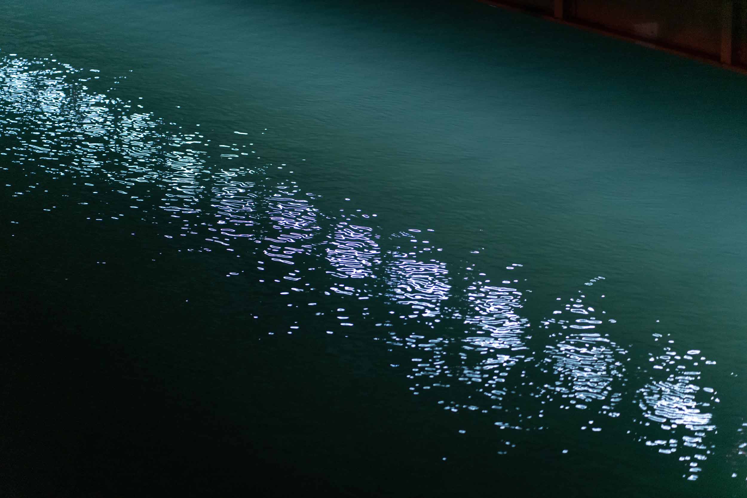 Time Slip: close-up of reflections on water surface of river