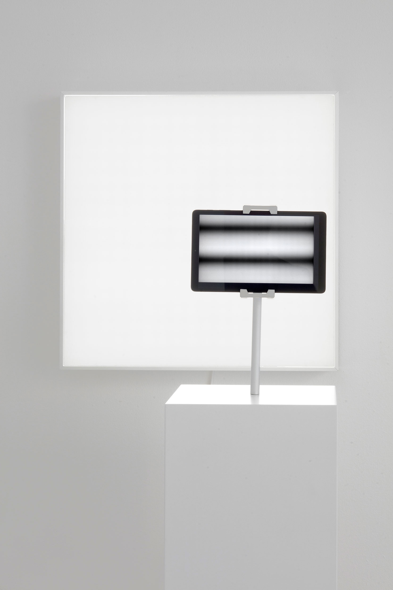 Two Views: small screen on pedestal in front of large screen in background