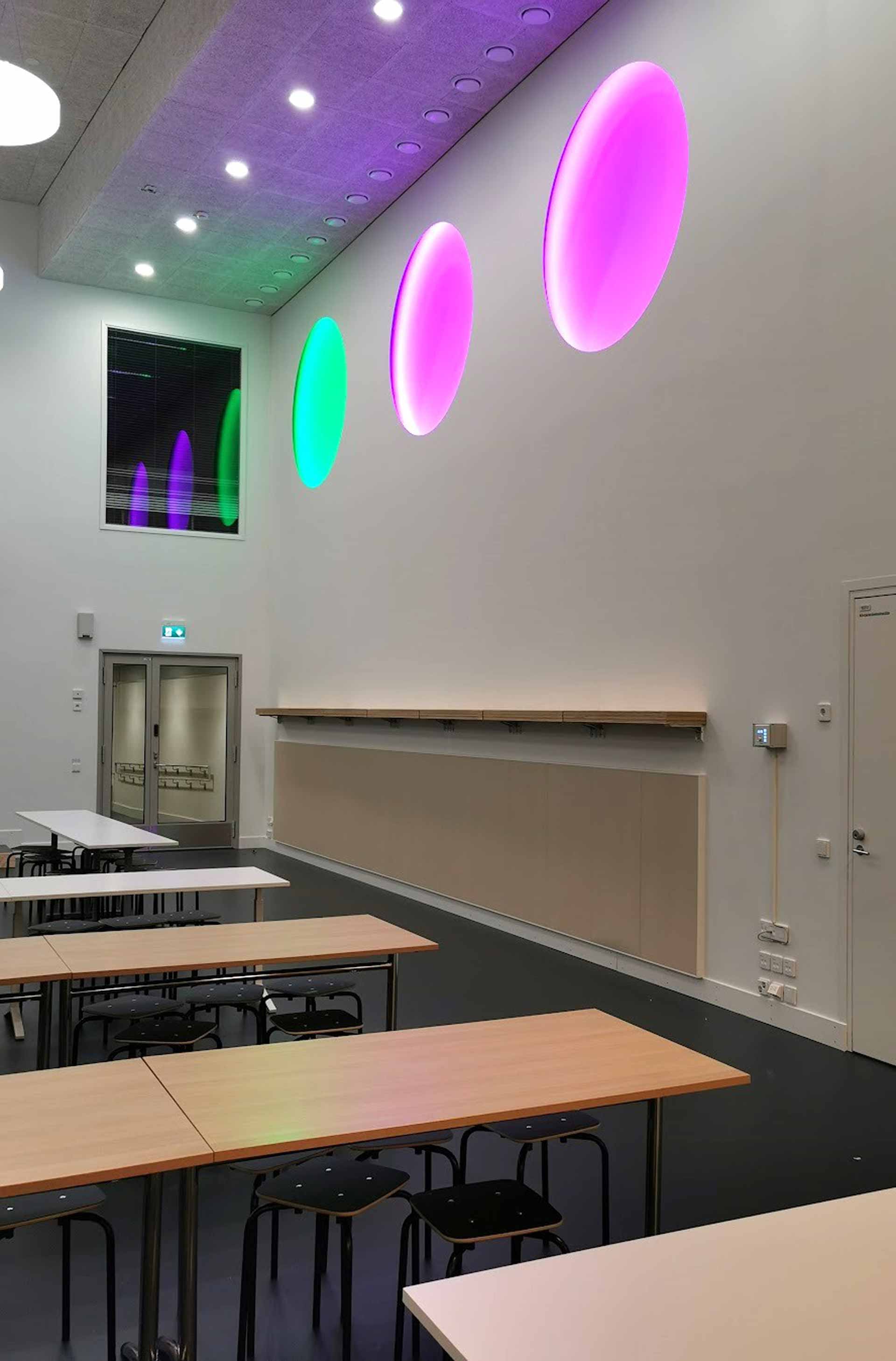 Installation from beneath lit in green, purple and purple