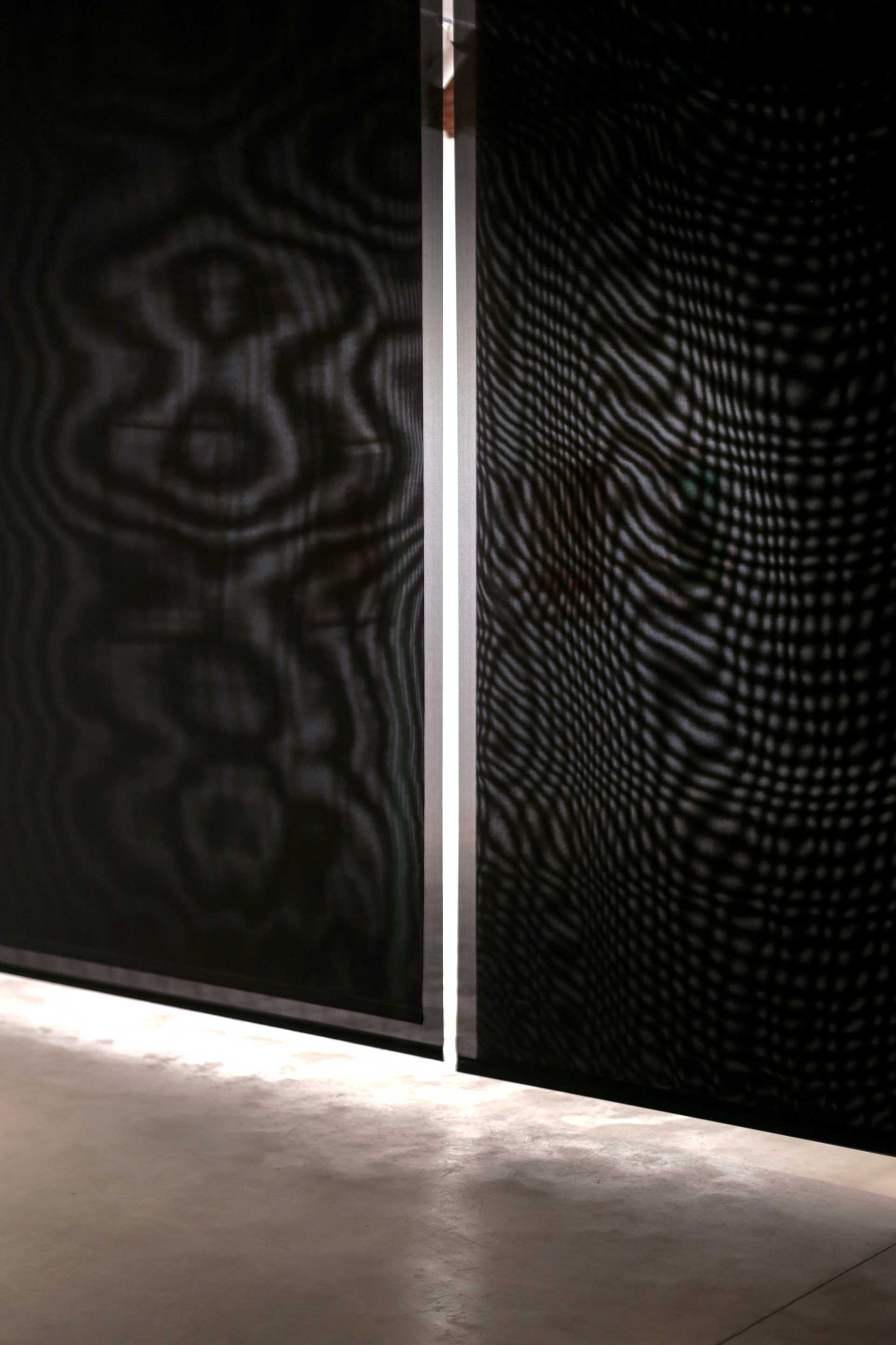 Blind Zone; close-up of black blinds with Moiré patterns