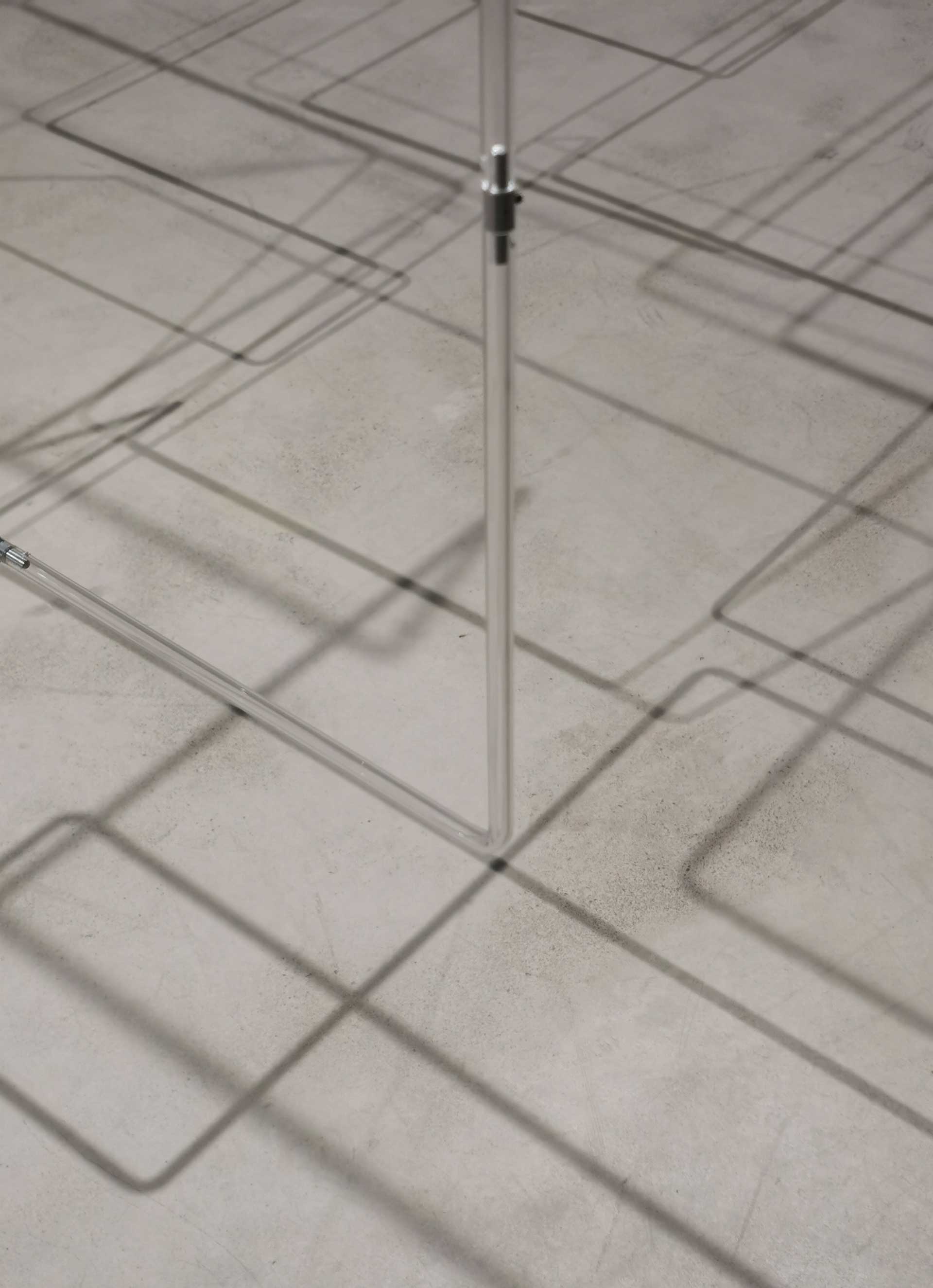 Linkage; close-up of acrylic tubes and shadows on floor