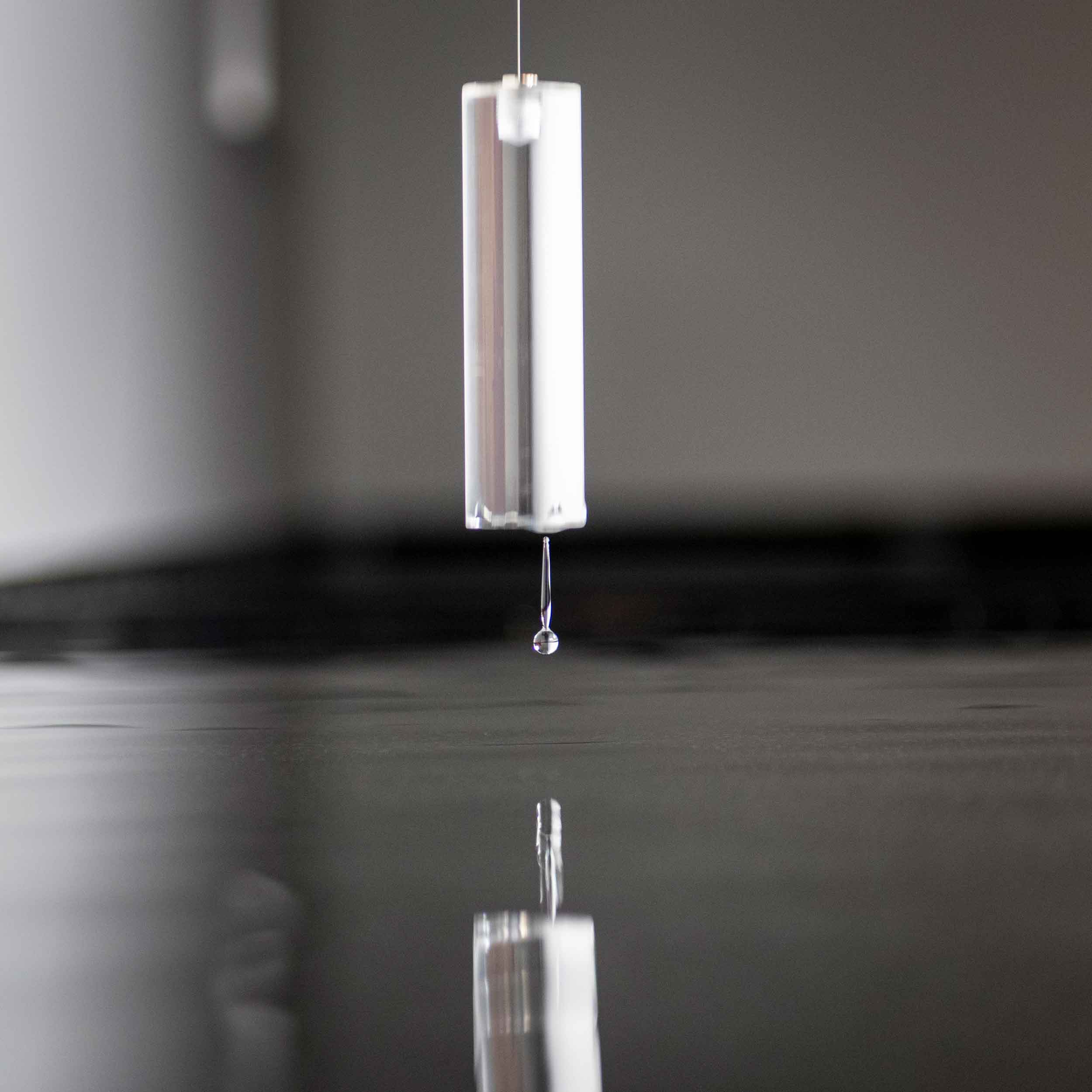 Close-up of acrylic counter weights moments before touching the water surface
