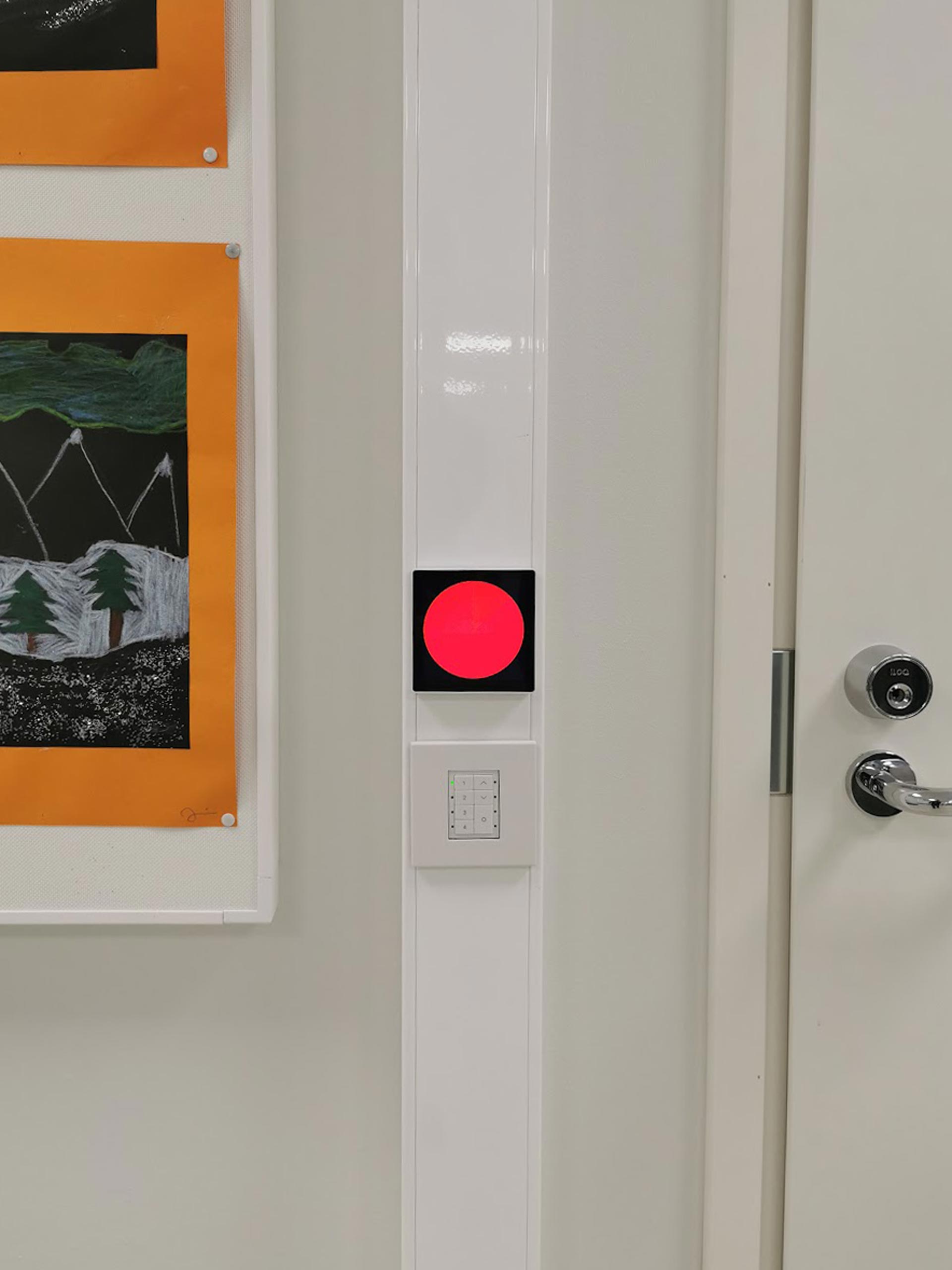 Touchscreen with a red circle in classroom